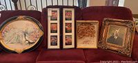 Overall shot of four framed items on sofa
