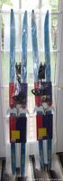 Two pairs of junior cross country skis in original packaging, skis are blue and white and measure 160cm each.