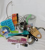 Photo of all the assorted kitchen items including banana holder, ice cube tray, utensils, straws, and cookie jar