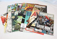 Photo showing a spread of approximately 18 Marvel comic books featuring characters Spider-Man, Inhumans, Master of Kung Fu among others.