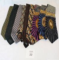 Nine men's silk ties laid flat showing various patterns and colors