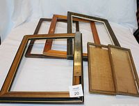 All picture frames laid on white backdrop with a ruler for size reference.