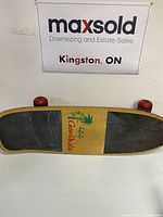 Top view of the wooden skateboard with grip tape and Ganida's branding