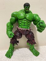 Front view of 2011 Hulk Marvel figure standing about 8 inches tall, showing muscular build and torn purple pants.