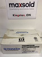 Original cardboard box for a Pioneer CT-W603RS cassette deck, used as background in photo, unrelated to the lot contents