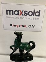 Front view of the blue mountain pottery horse figurine with a rich green glaze against a white background.