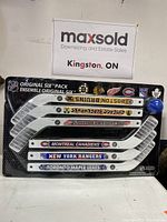 Front view of six mini hockey sticks arranged horizontally on original packaging with NHL team logos and branding visible.