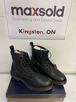 Pair of black winter boots size 11 in front of maxsold Kingston backdrop, showing boots all around.