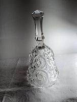 Front view of the clear Czechoslovakian crystal collectible bell with detailed cut patterns and faceted handle