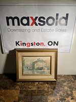 Framed print titled 'Babcock Mill' by Keirstead in gold frame on a dark surface.