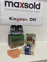 View of entire lot showing the View-Master stereoscope, box, view reels, reel list, and instruction sheet.