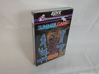 Front and angled view of the sealed Summer Games Atari 2600 game box showing neon athlete artwork and Epyx branding