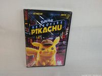 Front view of shrink-wrapped Detective Pikachu DVD case showing Pikachu wearing detective hat and city background