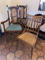 Overview of three wooden chairs, two with upholstered seats and twisted spindle arms, one with cane seat and vertical slats