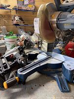 GMC multi-axis chop saw and Porter Cable nailer side view showing overall condition and placement on workbench.