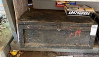 Wooden toolbox exterior with latch and worn black finish