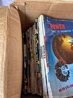 Box with multiple vintage Flying magazines stacked, showing spine wear and aging.