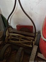 Manual push mower with metal blades and wheels