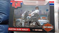 Front view of the GI Joe Electra Glide Harley Davidson police motorcycle with rider figure inside clear box showing packaging details and branding.