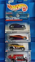 Photo of 4 Hot Wheels cars in original packaging stacked vertically showing different models and colors.