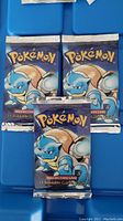 Three sealed booster packs laid flat showing front artwork