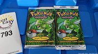 Overall view of two sealed Jungle booster packs displayed in blue tray.