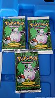 Four sealed Jungle booster packs arranged on blue surface