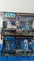 Two unopened Star Wars Commemorative Edition collectible figure packs showing figures and packaging design.