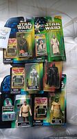 Full view of seven unopened Star Wars action figures from various series.