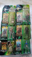 Photo showing eight unopened Star Wars action figures from Collection 2 Power of the Jedi with collectible Jedi Force Files cards included in each package