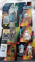 Photo showing six unopened Star Wars Power of the Force action figures including Emperor Palpatine, Luke Skywalker, Princess Leia, Boba Fett, Stormtrooper, and another figure.