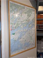 Full view of the 32x47 framed topographic map mounted on the wall showing terrain details of Gananoque to Wolfe Island.