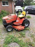 Full side view showing mower body, deck and seat