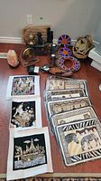 Lot items arranged on the floor including placemats, coasters, salt lamp, candle holders, and baskets
