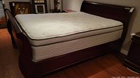 Front angled view showing entire queen bed frame with mattress in place