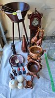 Wide view of all wooden decor items, figurines, clock, bowls, giraffes, and glass jars