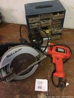 Full lot showing Black & Decker circular saw, orange drill, and metal organizer box with screw drawers