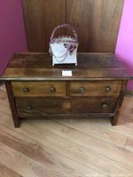 Wood side dresser with three drawers and round metal handles, measuring approximately 38 in length, 19 in depth, and 21 in height.