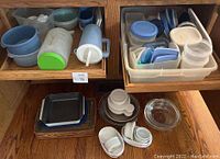 Two shelves displaying plastic containers and glass dishes. Top shelf has multiple plastic containers in blue and white with lids. Bottom shelf shows glass bakeware including round and rectangular dishes, some with lids.