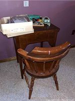 Wooden drop-down table with drawer and matching wooden chair, showing overall furniture setup for sewing machine use