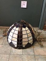 Full view of stained glass dome lamp and metal hanging chain