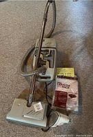 Kenmore 4.0 canister vacuum with hose, wand, floor head, and 13 vacuum canister bags in packaging.