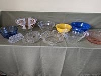 Full display of all bowls, platters, and butter dish arranged on cloth surface