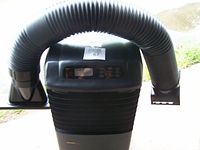 Top front view of the Danby portable air conditioner and heating unit showing flexible exhaust duct and front grille.