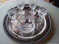 Five Waterford Boyne sherry glasses and Waterford Lismore footed bowl displayed on silver plate tray