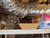 Large punch bowl and rectangular dish on shelf with plastic kitchen containers