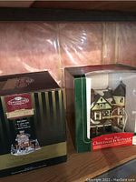 Photo of two boxed Christmas village buildings: Norwood Hills Lobster Shanty and Santa's Best Christmas in Vermont.