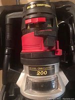 Photo of the Sears Craftsman 200 dustless router with dust extraction and adjustment features, inside its black carrying case.