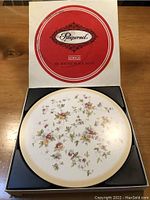 Original boxed set of six round Pimpernel acrylic place mats featuring floral design.