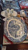 Full view of ceramic set arranged on table, featuring turkey platter, gravy boats, butter dish, honey pot, and serving platter
